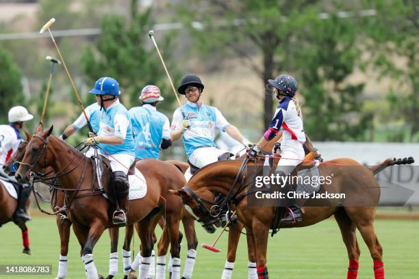 Steve Cox, Prince Harry, Duke of Sussex and Ashley Van Metre play polo during the Sentebale ISPS Handa Polo Cup 2022 on August 25, 2022 in Aspen,...