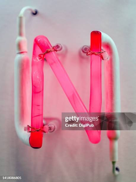neon single capital letter 'n' - fluorescent light stock pictures, royalty-free photos & images