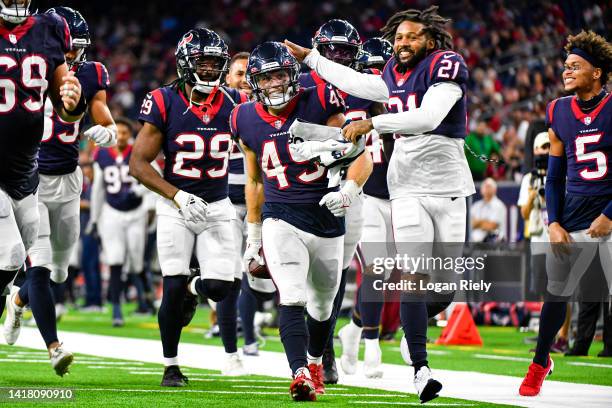 Ogbonnia Okoronkwo celebrates with Steven Nelson of the Houston Texans and the rest of the team after intercepting a pass in the fourth quarter...