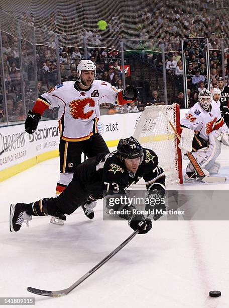 Michael Ryder of the Dallas Stars skates the puck past Mark Giordano of the Calgary Flames at American Airlines Center on March 24, 2012 in Dallas,...