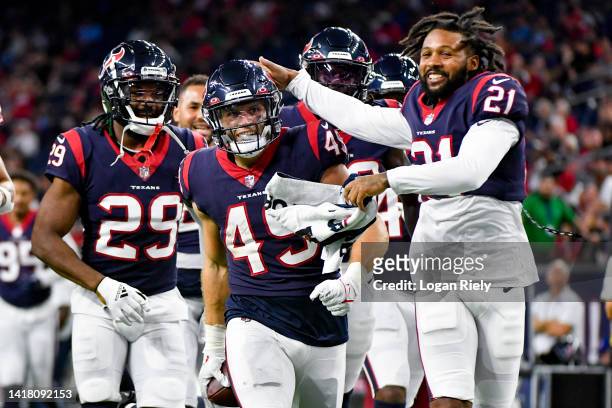 Ogbonnia Okoronkwo celebrates with Steven Nelson of the Houston Texans and the rest of the team after intercepting a pass in the fourth quarter...