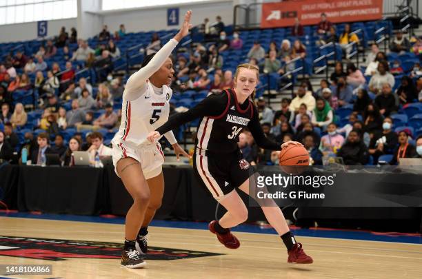 Sam Breen of the UMass Minutewomen handles the ball against Tenin Magassa of the Dayton Flyers during the Championship game of the 2022 Women's...