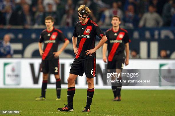 Daniel Schwaab, Simon Rolfes and Stefan Reinartz of Leverkusen look dejected after the second goal during the Bundesliga match between FC Schalke 04...