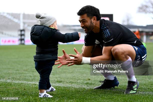 Richie Mo'unga of the All Blacks picks up his son Marley Mo'unga during the New Zealand All Blacks Captain's Run at Orangetheory Stadium on August...