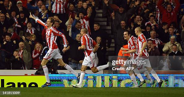 Stoke City's English striker Peter Crouch celebrates scoring the opening goal of the English Premier League football match between Stoke City and...