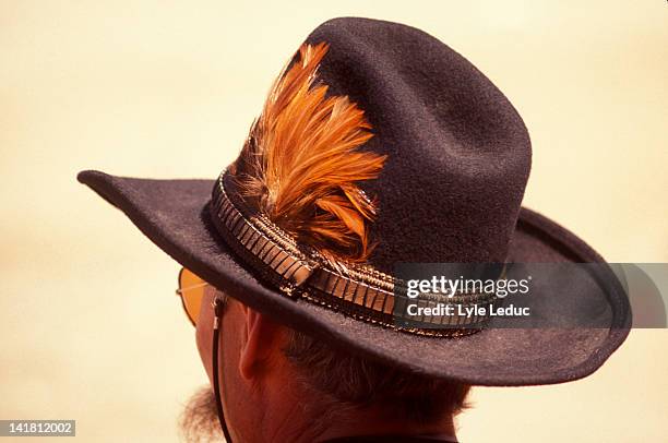 stuck a feather - feather hat stock pictures, royalty-free photos & images