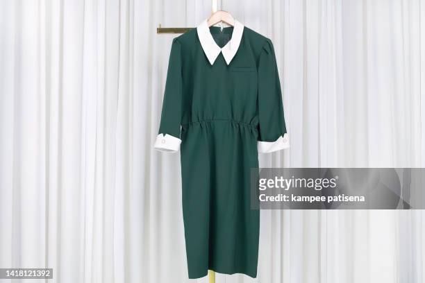 green dress hanging from coat hanger - blue dress hanger stock pictures, royalty-free photos & images