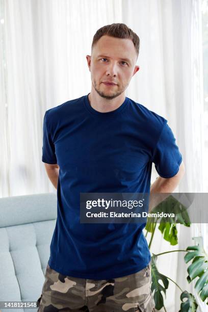 serious male looking at camera - camo pants stock pictures, royalty-free photos & images