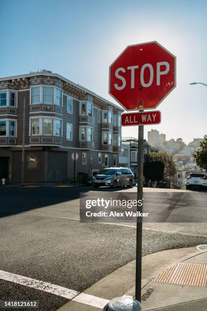 stop stop sign on san francisco city street intersection - stopschild stock-fotos und bilder