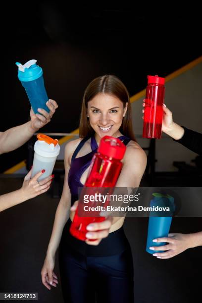 smiling sportswoman with bottle of water in gym - bottle water sport stock pictures, royalty-free photos & images