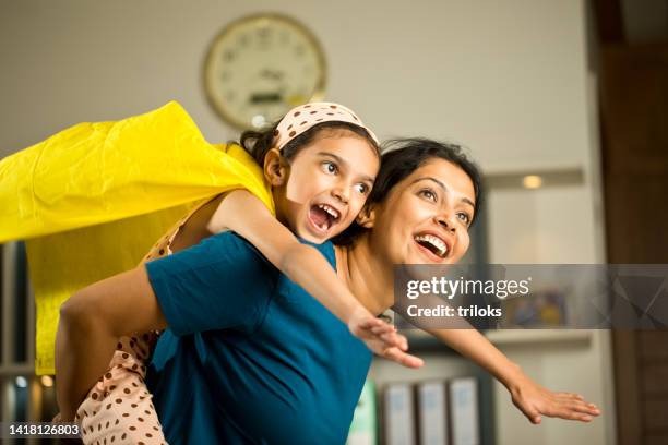 girl having fun with her mother at home - superhero mom stock pictures, royalty-free photos & images