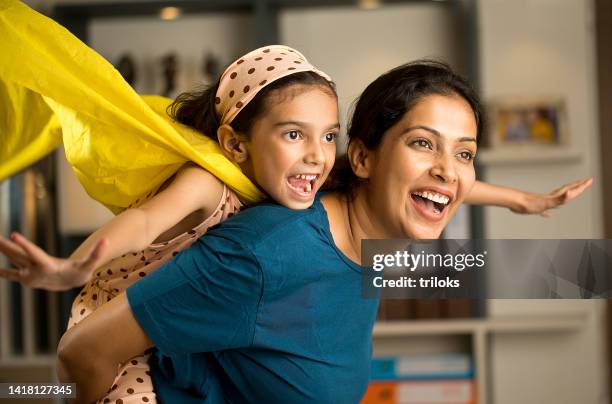 girl having fun with her mother at home - superhero mom stock pictures, royalty-free photos & images