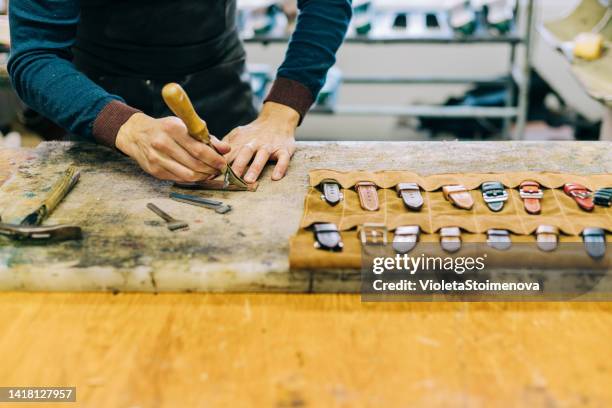 young craftsperson making leather watch strap. - strap stock pictures, royalty-free photos & images