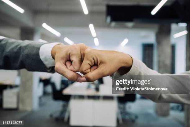 fist bump greeting! - fist bump stock pictures, royalty-free photos & images