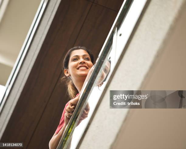 happy woman admiring view from balcony - women india partition stock pictures, royalty-free photos & images