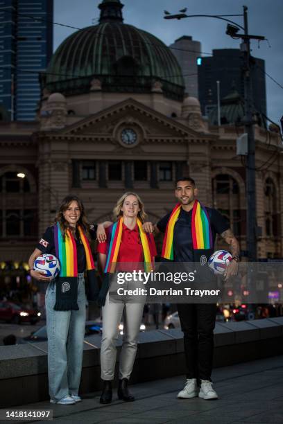 Melbourne Victory player Kayla Morrison, Adelaide United player Anne Grove and Melbourne Victory player George Timotheou pose for a photo during a...