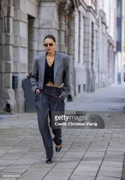 Chelsey Weimar wears Shoes / Prada, Grey pants with wide legs, Black gilet with buttons / Shona Joy, Grey cropped blazer / cut vintage, Sunglasses /...