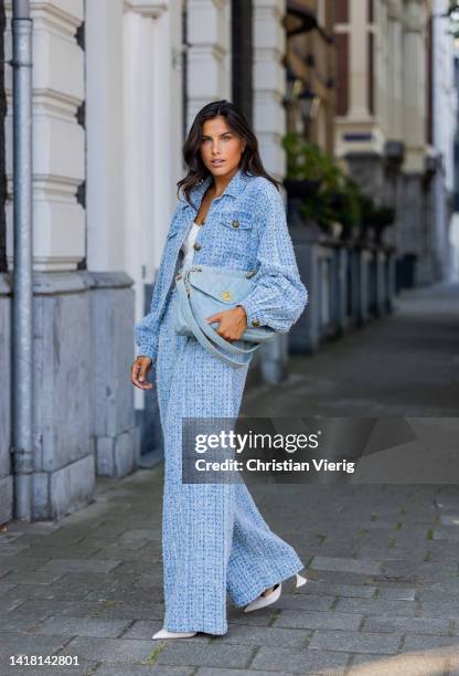 Kae Sutherland wears jeans set, pants and jacket Gestuz, white top, blue bag Chanel, jewellery 24Kae during a street style shoot on August 25, 2022...