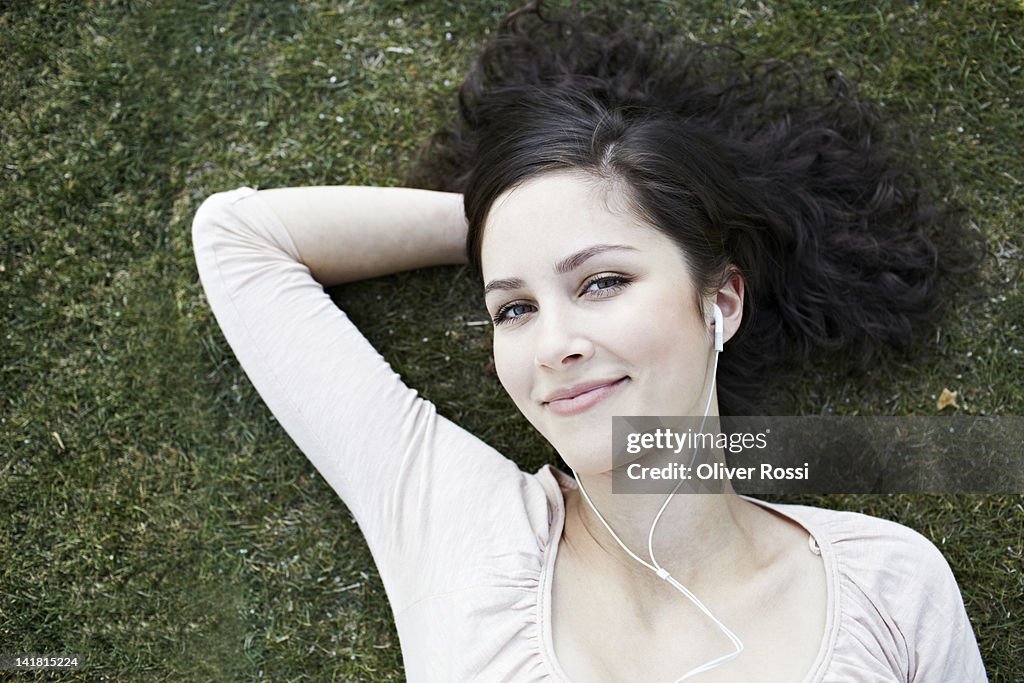 Portrait of a young woman laying in the grass