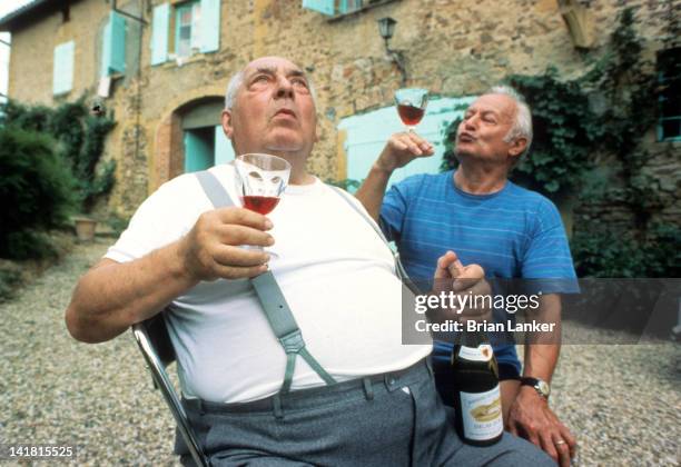 Portrait of France Olympians Louis Chaillot and Maurice Perrin drinking wine at his vineyard. Chaillot and Perrin won 1932 gold in tandem event....