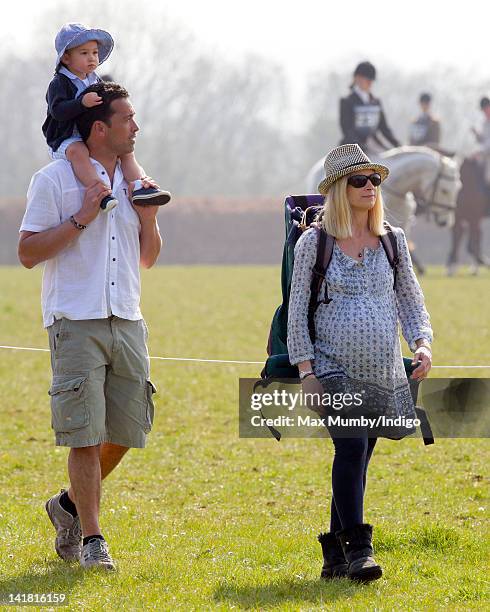 Gary Lewis carries daughter Senna Lewis as they and Lady Davina Lewis attend the Gatcombe Horse Trials at Gatcombe Park, Minchinhampton on March 24,...