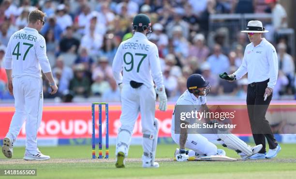 England batsman Ben Stokes reacts after pulling up with a knee injury during day two of the second test match between England and South Africa at Old...