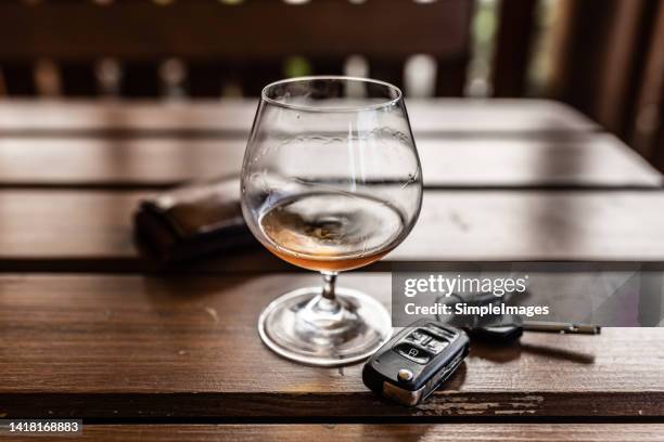 car keys and glass of alcohol on table in pub or restaurant. - crash bar stock pictures, royalty-free photos & images