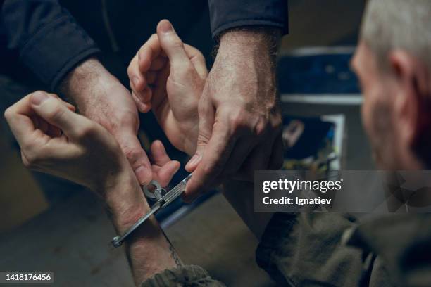 removing handcuffs from the top view - boei stockfoto's en -beelden