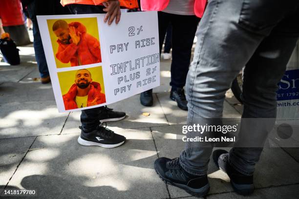 Man holds a poster featuring a popular meme showing the Canadian rapper Drake during a strike action protest outside the Mount Pleasant Royal Mail...