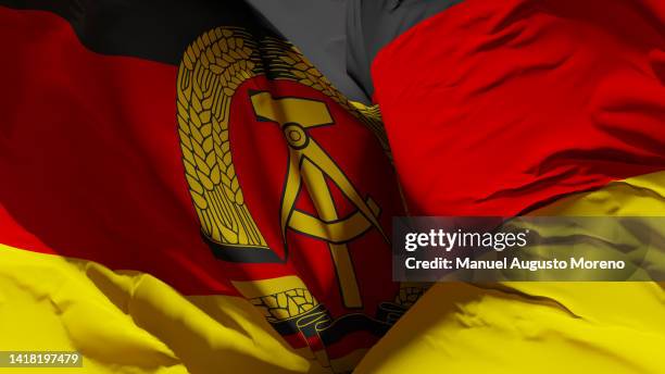 historical flag of the german democratic republic (until 1990) - reunification stock-fotos und bilder