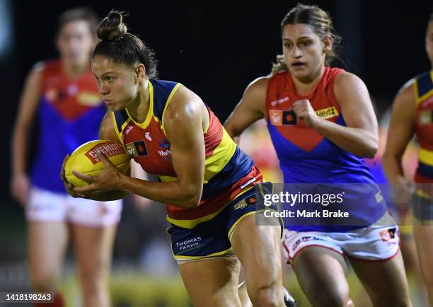 Stevie-Lee Thompson of the Adelaide Crows gets away from Eliza West of the Demons during the round one AFLW match between the Adelaide Crows and the...