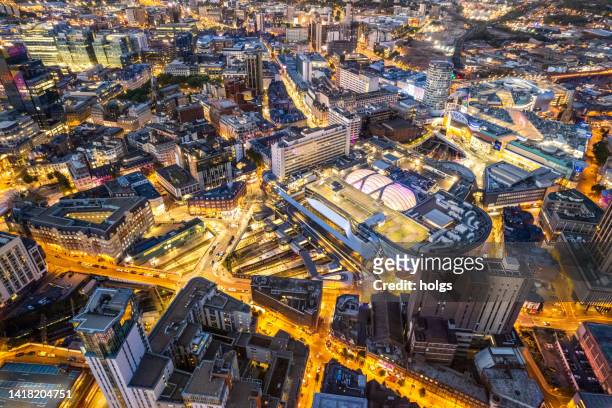 birmingham united kingdom aerial view over the city center by night including central train station - birmingham skyline stock pictures, royalty-free photos & images