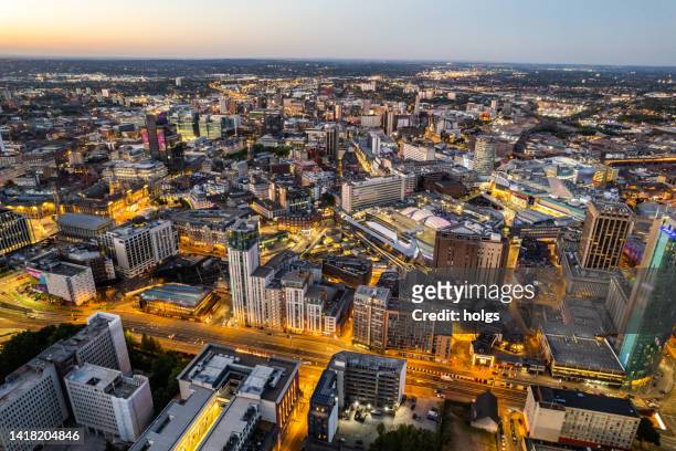 birmingham united kingdom aerial view over the city center by night including central train station - birmingham england stock pictures, royalty-free photos & images