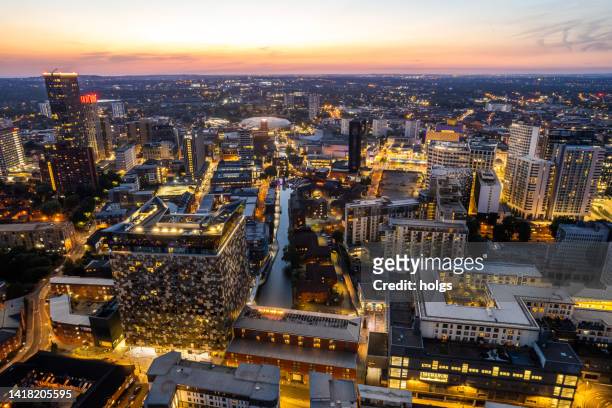 birmingham united kingdom aerial view over the city center by night including central canals - birmingham skyline stock pictures, royalty-free photos & images