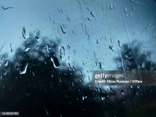 full frame shot of wet glass window during rainy season - skyfall bildbanksfoton och bilder