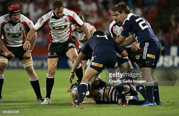 Joe Pietersen of the Stormers secures the ball while Franco van der Merwe and Butch James look on during the 2012 Super Rugby match between MTN Lions...