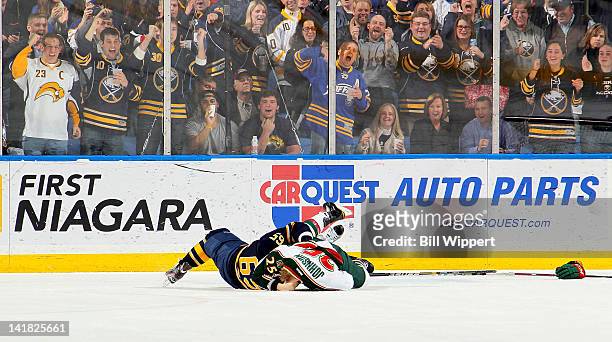 Fans cheer as Travis Turnbull of the Buffalo Sabres and Nick Johnson of the Minnesota Wild have a second period fight at First Niagara Center on...