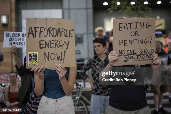 Protesting Plug Cards Protesters hold placards during a demonstration against rising energy ...