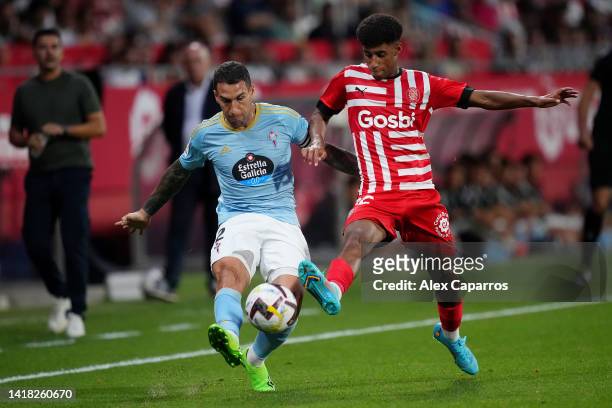 Hugo Mallo of RC Celta battles for possession with Oscar Urena of Girona FC during the LaLiga Santander match between Girona FC and RC Celta at...