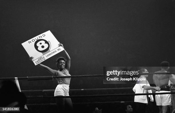 Ring girl' announces the 8th round in a Heavyweight Championship bout between American boxer Muhammad Ali and Uruguayan Alfredo Evangelista at the...