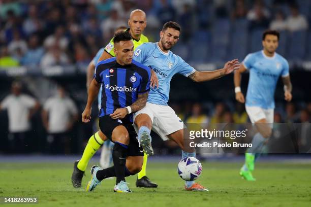Lautaro Martinez of FC Internazionale battles for possession with Danilo Cataldi of SS Lazio during the Serie A match between SS Lazio and FC...