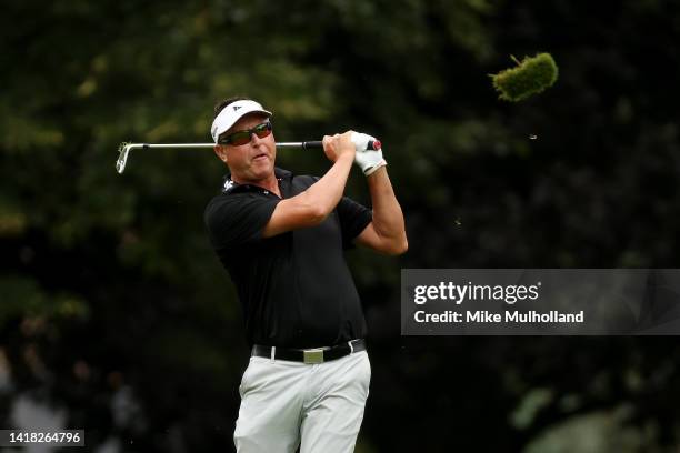 Robert Allenby of Australia hits an approach shot on the first hole during the first round of The Ally Challenge at Warwick Hills Golf And Country...