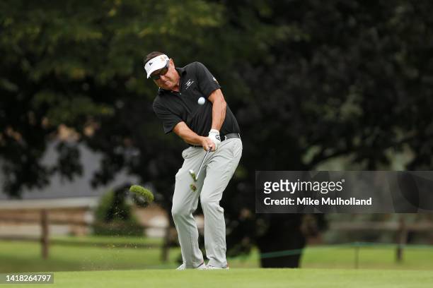 Robert Allenby of Australia hits an approach shot on the first hole during the first round of The Ally Challenge at Warwick Hills Golf And Country...
