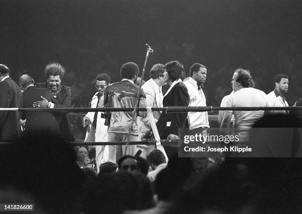 American boxing promotor Don King embraces an unidentified man in the ring during a Heavyweight Championship bout between American Muhammad Ali and...