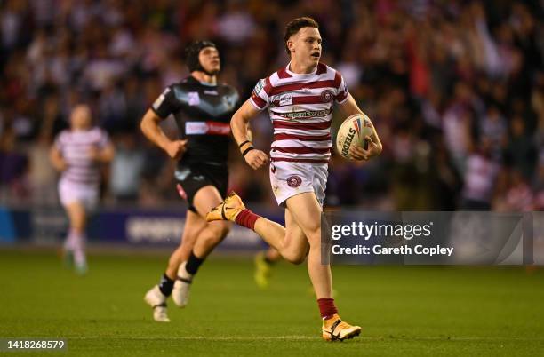 Jai Field of Wigan runs in his team's second try during the Betfred Super League match between Wigan Warriors and St Helens at DW Stadium on August...