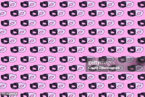 pattern of black and white cardboard masks, painted and cut out by a child, to celebrate carnival, with hard shadow, on pink background. carnival and masquerade celebration concept. - gala stock pictures, royalty-free photos & images