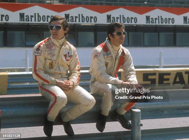 Jacky Ickx of Belgium and Mario Andretti of the United States, drivers of the Scuderia Ferrari 312B2 Ferrari F12 in the pits before the start of the...