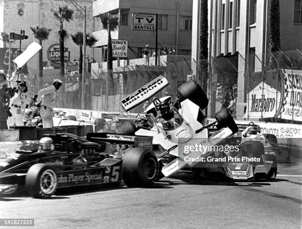 James Hunt of Great Britain and driver of the MarlboroTeam McLaren M23 Ford V8 is launched into the air after hitting the rear wheel on the Martini...