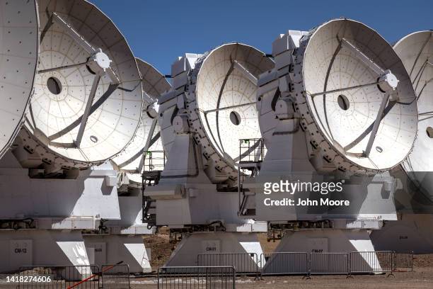 Massive antennas, part of the Atacama Large Millimeter/submillimeter Array radio telescope, stand in position on August 26, 2022 on the Chajnantor...