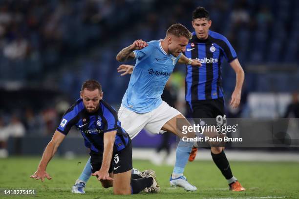 Ciro Immobile of SS Lazio is tackled by Stefan de Vrij of FC Internazionale during the Serie A match between SS Lazio and FC Internazionale at Stadio...